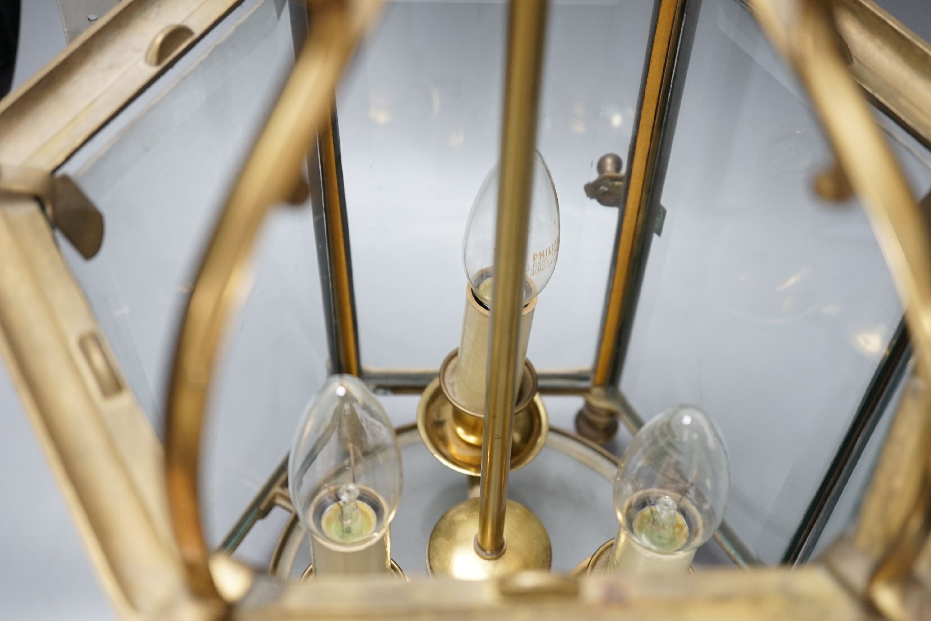 A three light brass hall lantern in hexagonal glass opening case - 56cm high excluding ceiling rose suspension